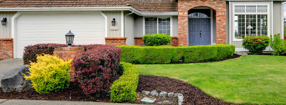 Home with trimmed shrubs and hedges in City 1, State.
